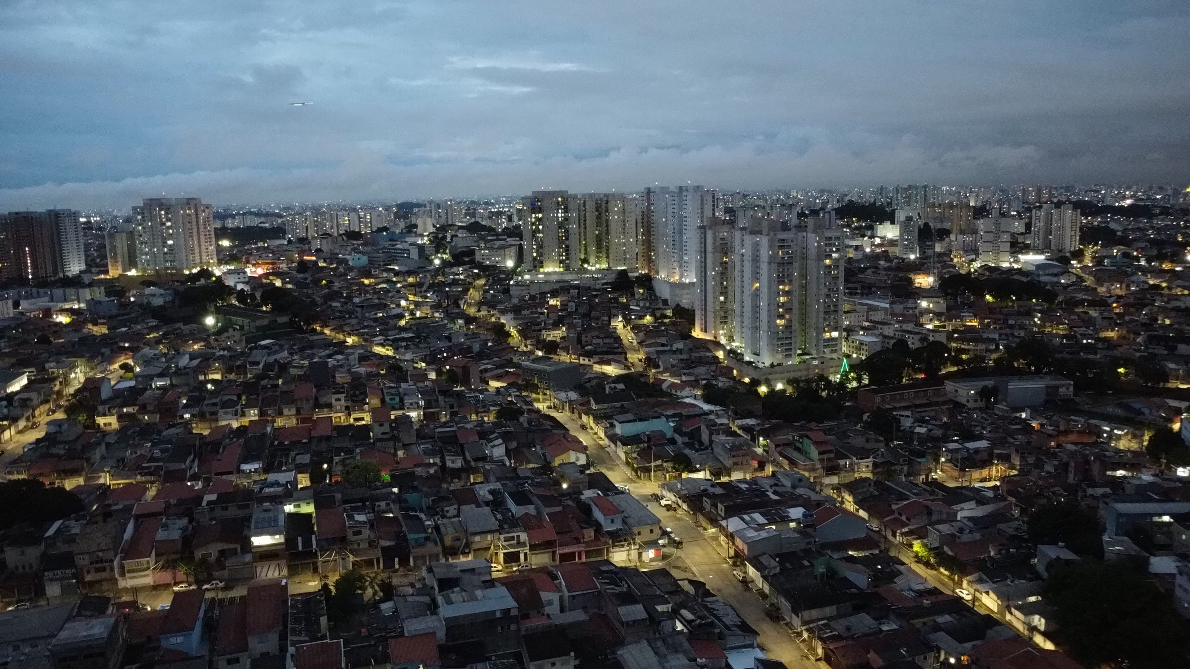 A city panorama at dusk with street lights on